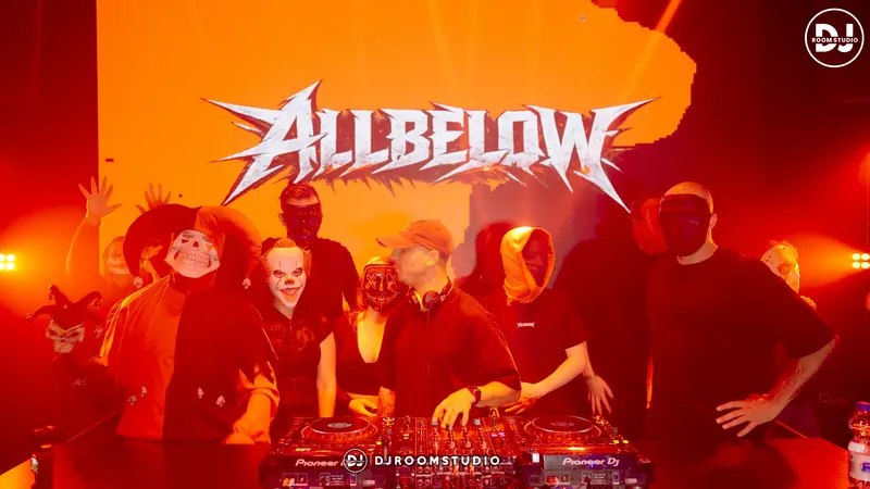 Allbelow playing in front of the LED wall with a masked crowd behind